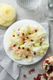 Photo of Delicious salad with Chinese cabbage, shrimps and pineapple served on grey table, flat lay