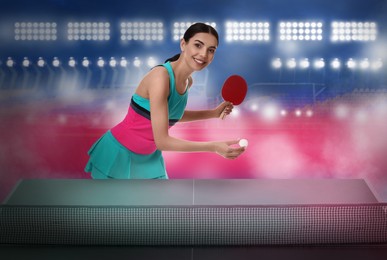 Beautiful young woman playing ping pong at stadium