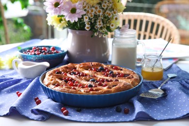 Delicious currant pie with fresh berries served on white table