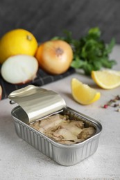 Photo of Open tin can of tasty cod liver on textured table