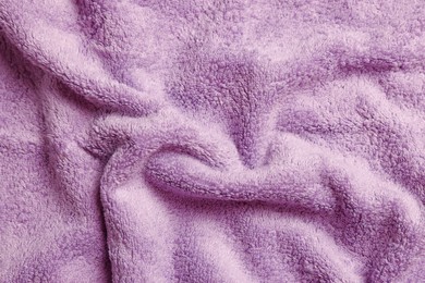 Soft crumpled pale purple towel as background, top view