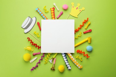 Flat lay composition with carnival items and blank card on green background. Space for text