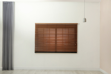 Photo of Window with closed blinds in empty room