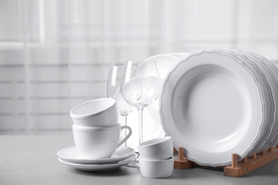 Set of clean tableware on light grey table