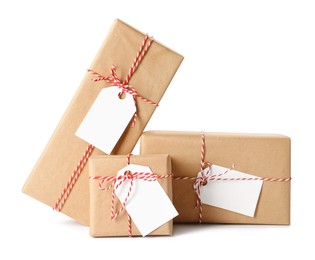 Gift boxes wrapped in kraft paper with tags on white background