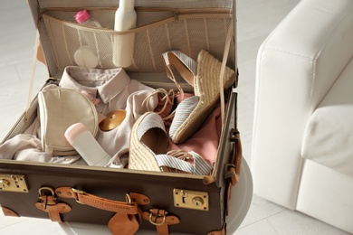 Vintage suitcase with deodorants and clothes at home