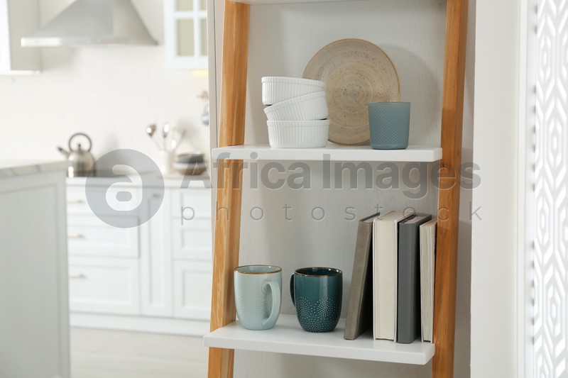 Photo of Decorative wooden ladder in stylish kitchen. Interior design