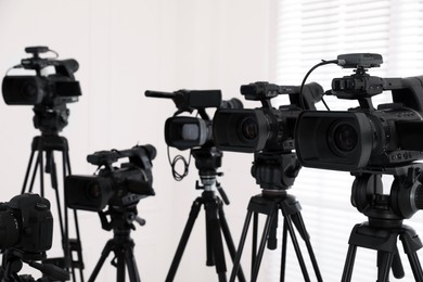 Modern video cameras indoors. Professional media equipment for broadcasting event