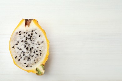 Photo of Delicious cut dragon fruit (pitahaya) on white wooden table, top view. Space for text