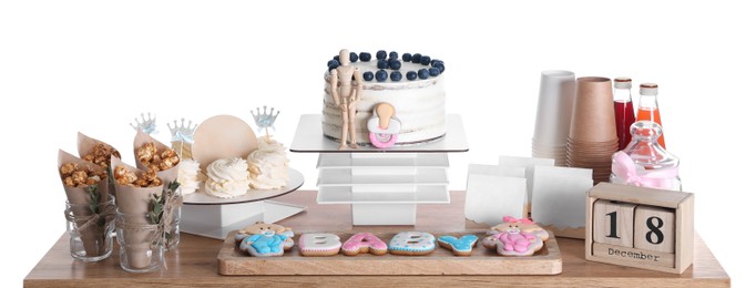 Baby shower party. Different delicious treats and decor on wooden table against white background