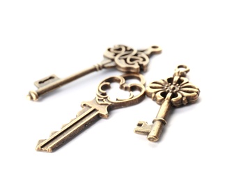 Bronze vintage ornate keys on white background