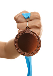 Woman holding bronze medal on white background, closeup. Space for design