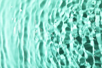 Closeup view of water with rippled surface on light blue background