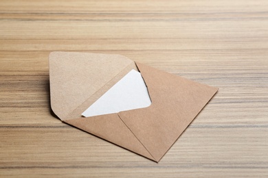 Brown paper envelope on wooden background. Mail service
