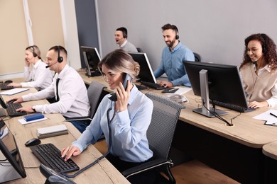Photo of Call center operators working in modern office