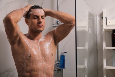 Man taking shower with gel at home