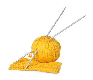 Soft yellow woolen yarn, knitting and metal needles on white background