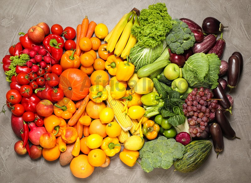 Assortment of organic fresh fruits and vegetables on grey background, flat lay
