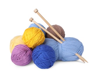 Soft woolen yarns and knitting needles on white background