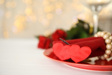 Elegant place setting on white table, closeup with space for text. Valentine's day romantic dinner
