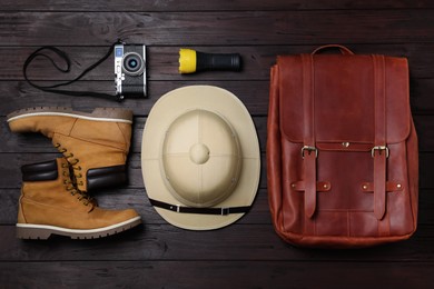 Flat lay composition with different safari accessories on wooden background