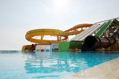 Beautiful view of water park with colorful slides and swimming pool on sunny day