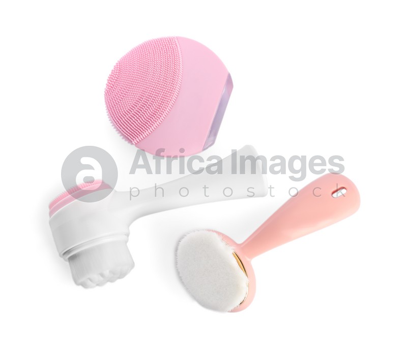 Photo of Face cleansing brushes isolated on white, top view. Cosmetic tools