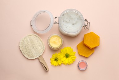 Flat lay composition with beeswax and cosmetic products on beige background