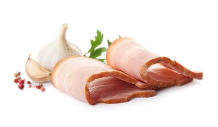 Slices of delicious smoked bacon with parsley, peppercorns and garlic on white background