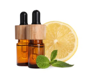 Bottles of citrus essential oil and fresh lemon isolated on white