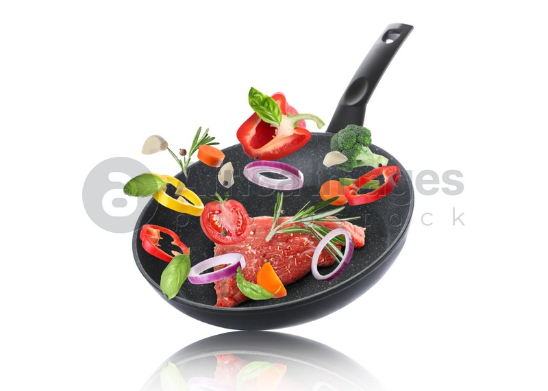 Tasty fresh ingredients and frying pan on white background