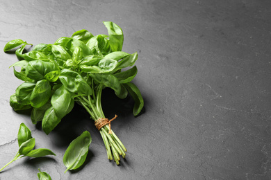 Bunch of fresh basil on grey table. Space for text