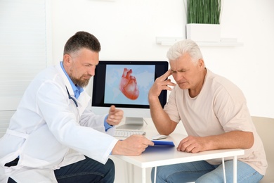 Male doctor working with patient in clinic. Cardiology consultation