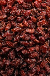 Dried red barberries as background, closeup view
