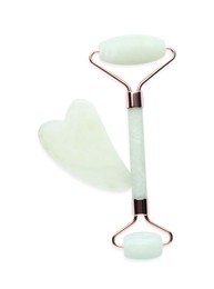 Jade gua sha tool and facial roller isolated on white, top view