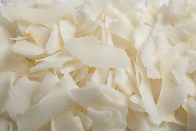 Delicious fresh coconut chips as background, closeup