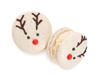 Tasty reindeer Christmas macarons on white background, top view