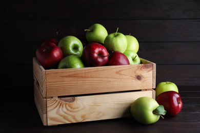 Photo of Fresh ripe red and green apples on black wooden table