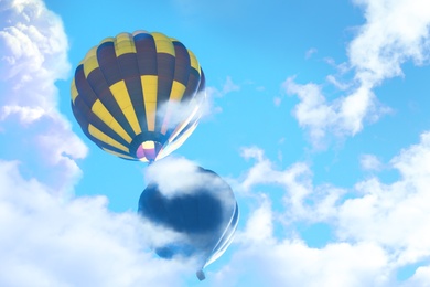 Fantastic dreams. Hot air balloons in blue sky with clouds 