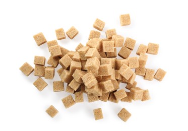 Pile of brown sugar cubes on white background, top view