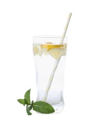 Glass with water, sliced lemon and mint on white background