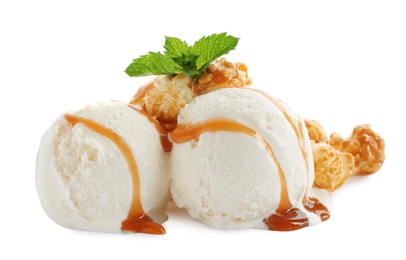 Scoops of delicious ice cream with caramel sauce, mint and popcorn on white background