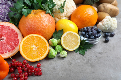 Different products rich in vitamin C on light grey table