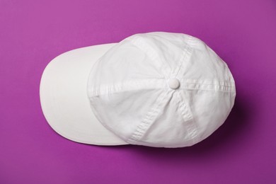 Baseball cap on purple background, top view. Mock up for design