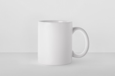 Blank ceramic mug on white background. Mockup for design