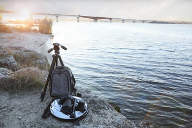 Professional photography equipment on rocky river coast