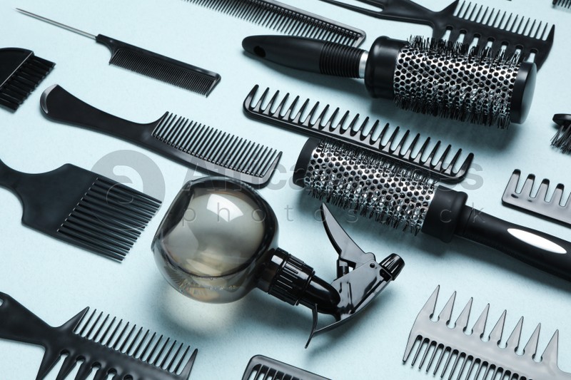 Composition with modern hair combs and brushes on light background