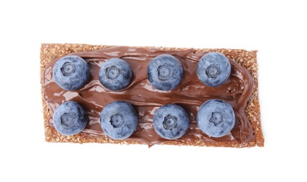 Photo of Fresh crunchy rye crispbread with chocolate spread and blueberries isolated on white, top view