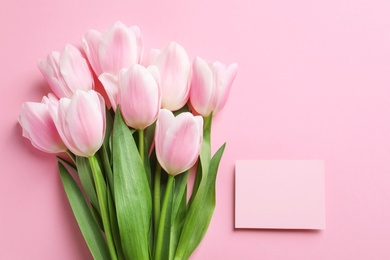 Beautiful tulips and card for Mother's Day on color background, top view