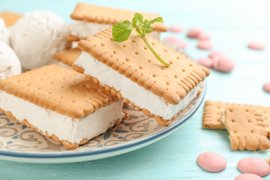 Sweet delicious ice cream cookie sandwiches on light blue wooden table, closeup
